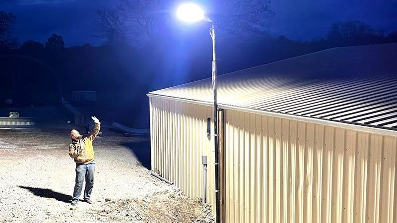 LED parking lot light installed on a pole providing bright outdoor illumination for a commercial building area at night