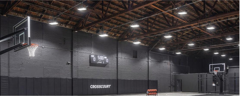 Indoor basketball gym equipped with LED canopy lights for high-efficiency sports lighting